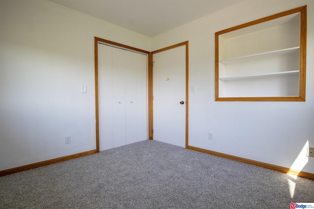 unfurnished bedroom featuring carpet and a closet