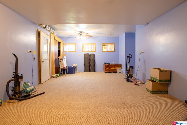 misc room with carpet floors and ceiling fan