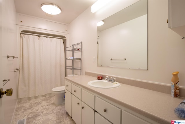 bathroom featuring tile patterned floors, vanity, and toilet