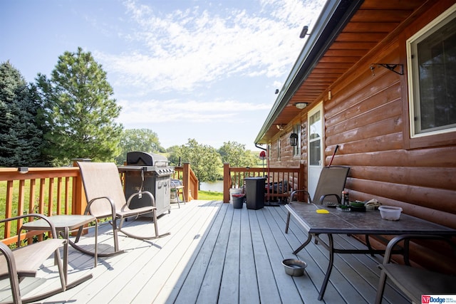 wooden deck with a grill