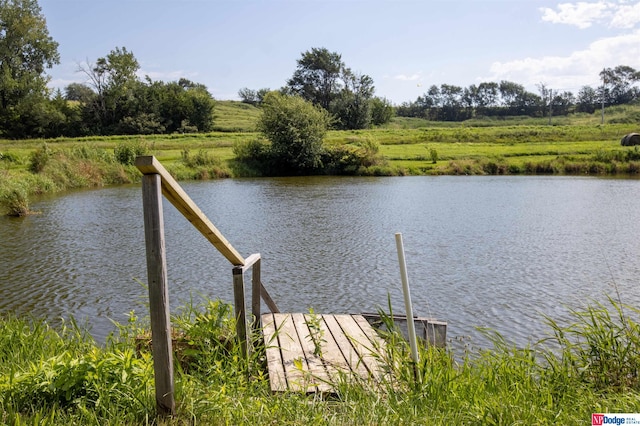 dock area with a water view and a rural view