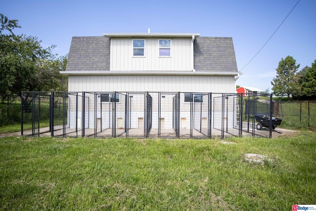 rear view of property with a yard