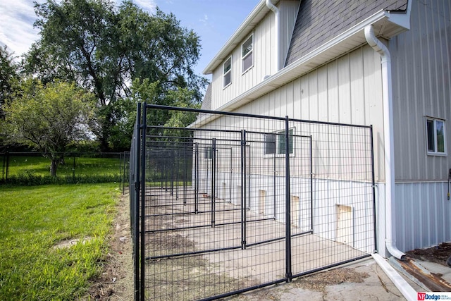 view of gate featuring a lawn