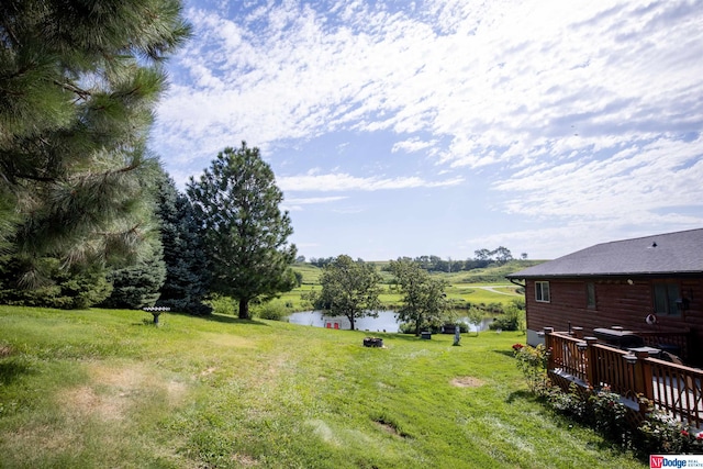 view of yard featuring a deck with water view