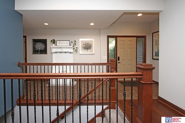 hallway with hardwood / wood-style floors