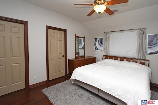 bedroom with dark wood-type flooring, lofted ceiling, and ceiling fan