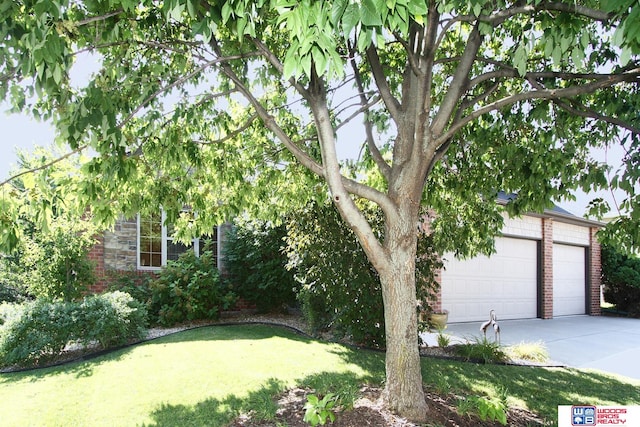 exterior space featuring a garage and a front lawn