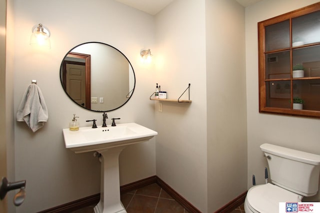 bathroom featuring tile patterned flooring and toilet