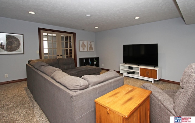 carpeted living room featuring french doors and a textured ceiling