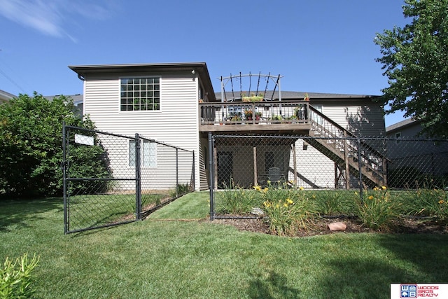 back of house featuring a yard and a wooden deck