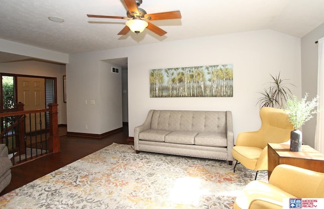 living room featuring dark wood-type flooring, vaulted ceiling, and ceiling fan