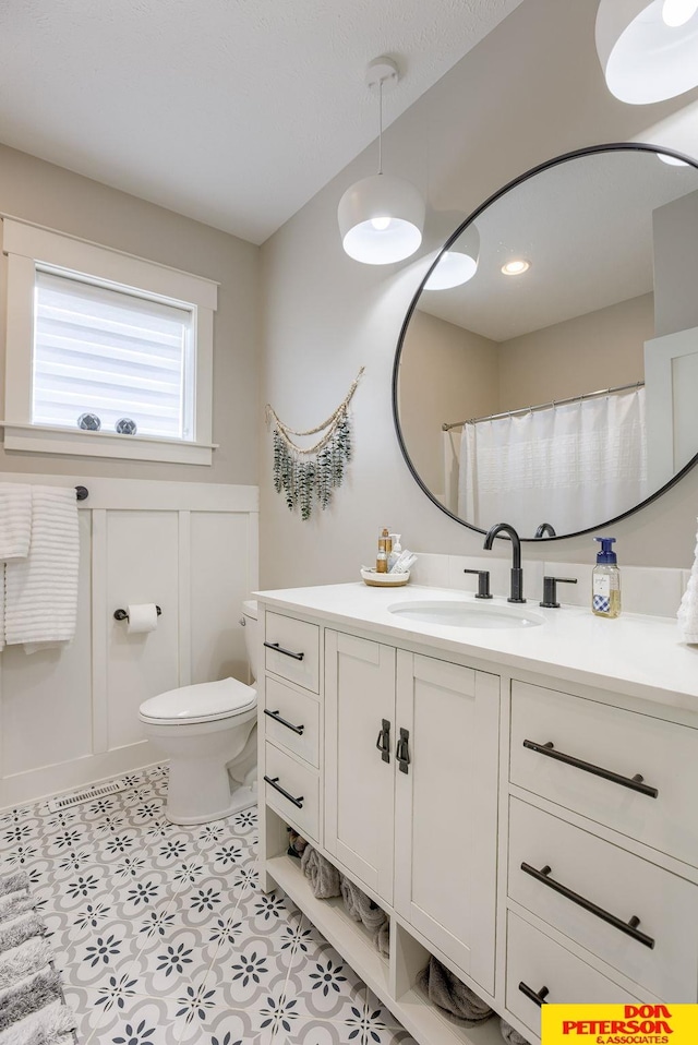 bathroom with tile patterned floors, vanity, and toilet