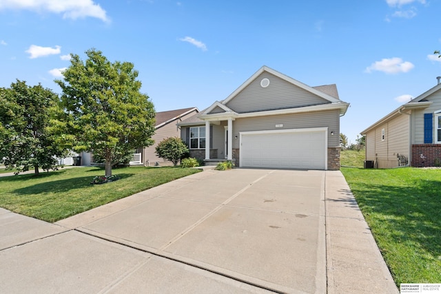 view of front of home with a garage, a front yard, and central AC unit