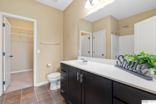 bathroom with tile patterned flooring, toilet, and vanity