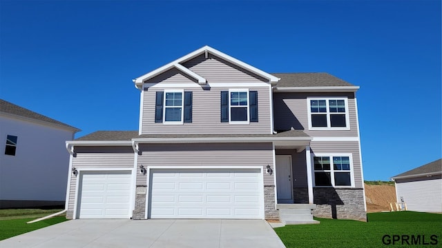 view of front of house with a garage and a front yard