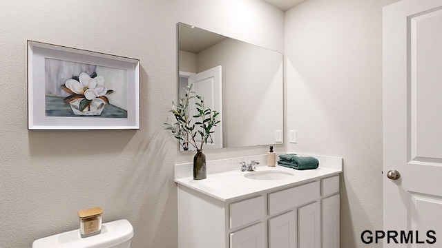 bathroom with vanity and toilet