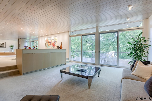 carpeted living room with wooden ceiling