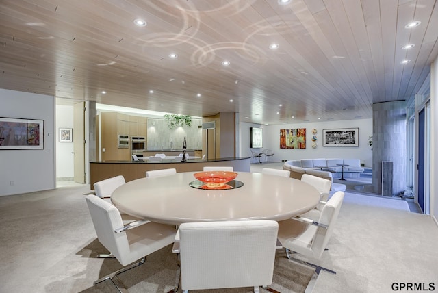 carpeted dining room with wooden ceiling