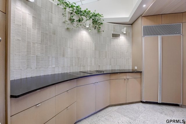 kitchen featuring light brown cabinets, light tile patterned floors, and paneled refrigerator