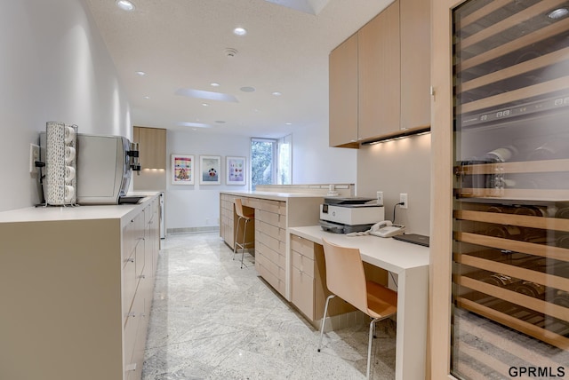 kitchen with light tile patterned floors and light brown cabinetry