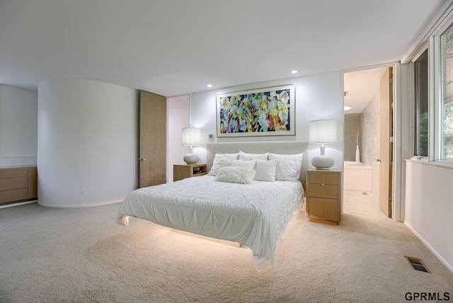 carpeted bedroom with connected bathroom