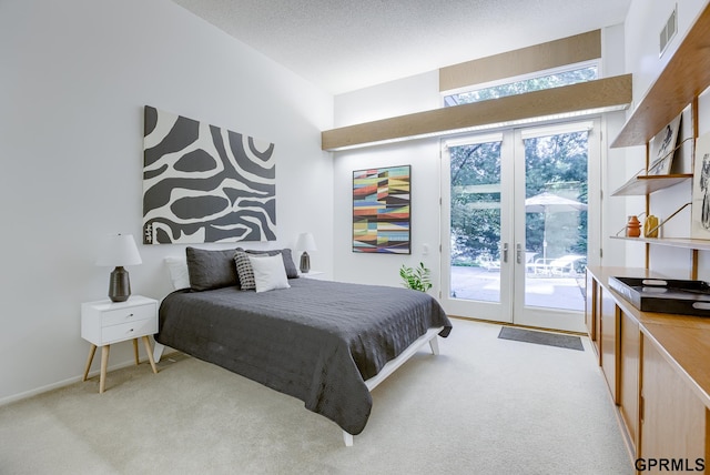 carpeted bedroom with access to outside, a textured ceiling, french doors, and multiple windows