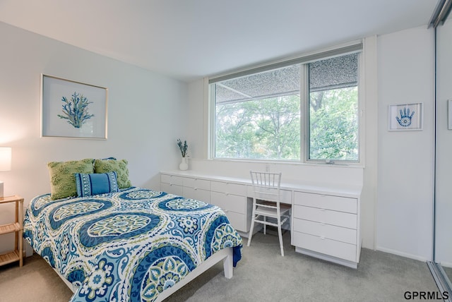 bedroom featuring light colored carpet