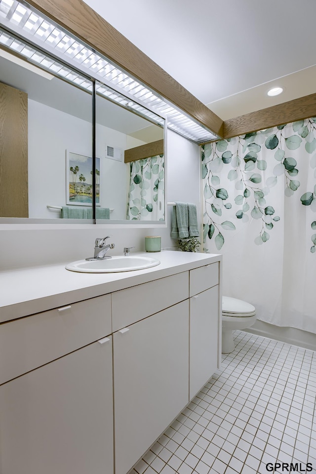 bathroom with vanity, toilet, and tile patterned flooring