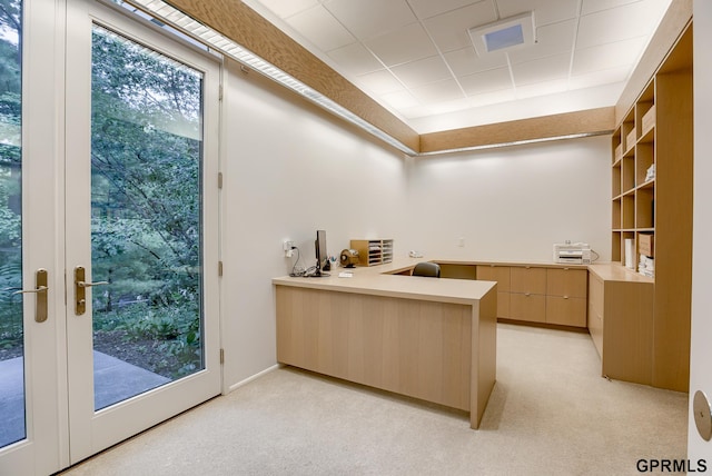 carpeted home office featuring french doors