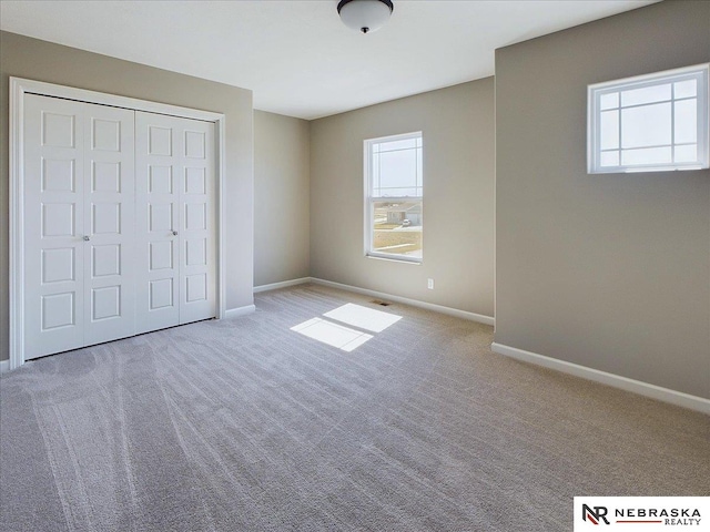 unfurnished bedroom with carpet and a closet