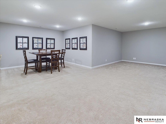 dining room featuring light carpet