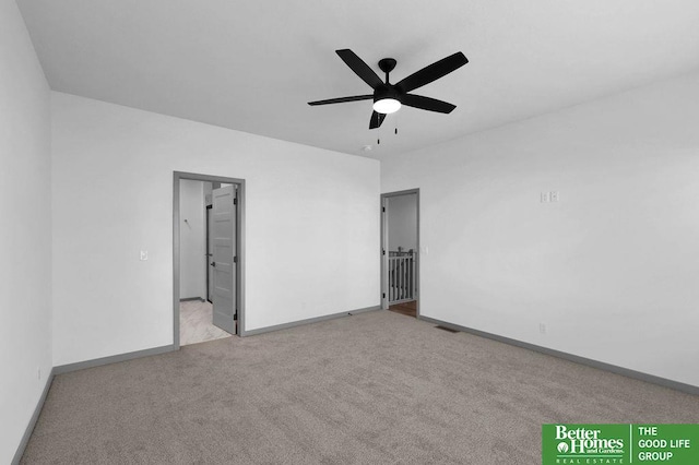 carpeted spare room with ceiling fan