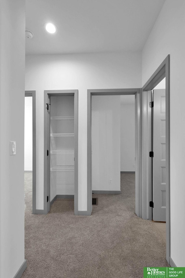 unfurnished bedroom with light carpet and multiple closets