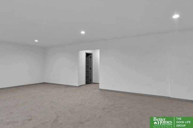 unfurnished room featuring light carpet