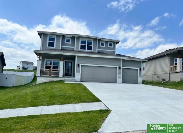 view of front of home featuring a garage, a front lawn, and a porch