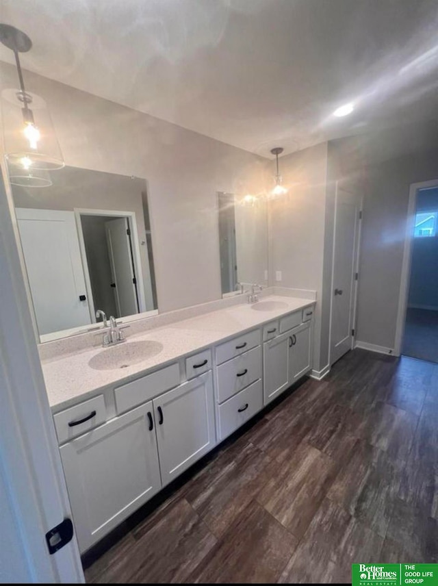 bathroom with hardwood / wood-style flooring and vanity