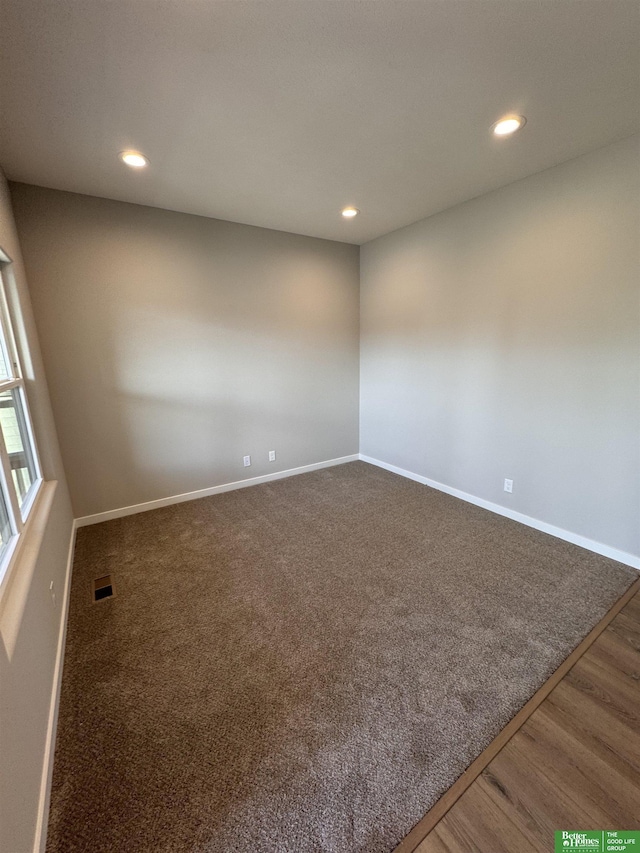 spare room with dark hardwood / wood-style flooring