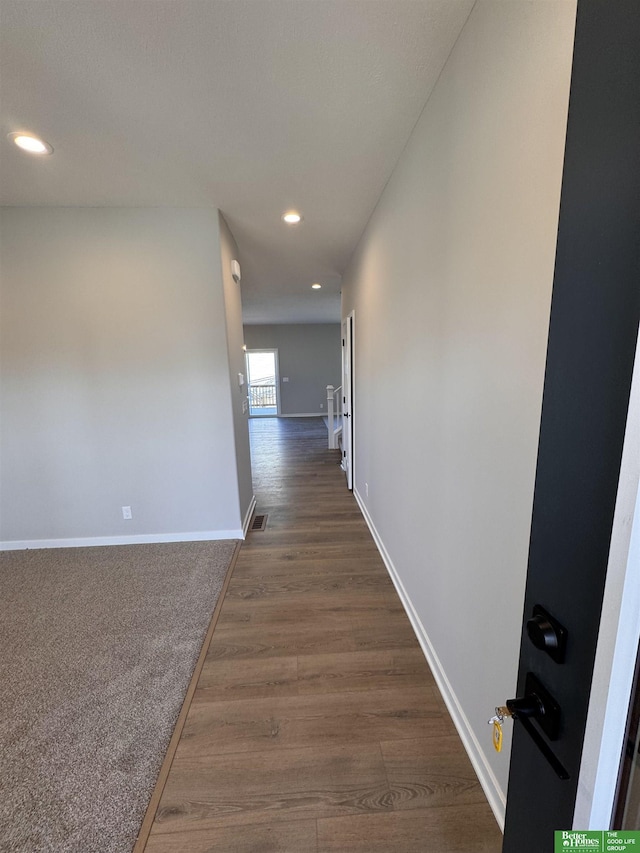 corridor featuring dark hardwood / wood-style floors