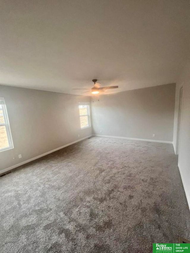 empty room featuring carpet and ceiling fan