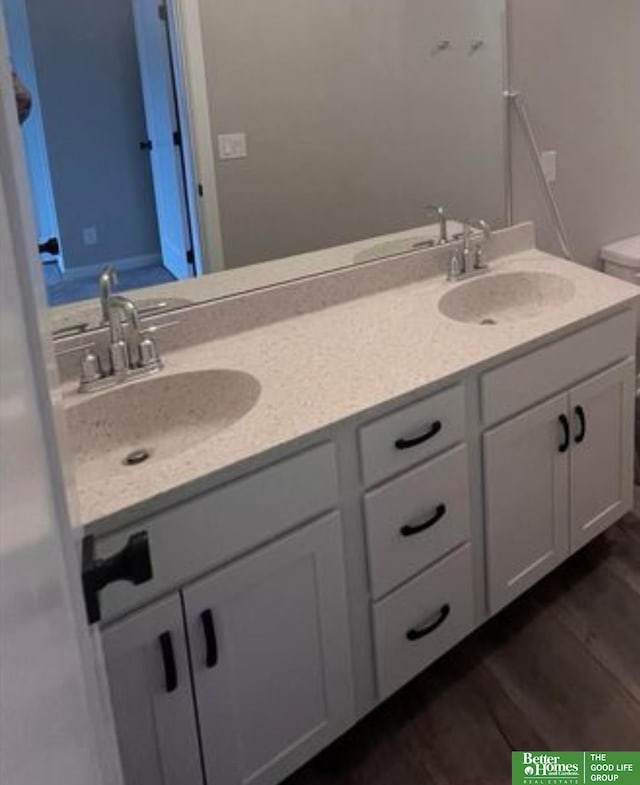 bathroom with vanity, hardwood / wood-style floors, and toilet