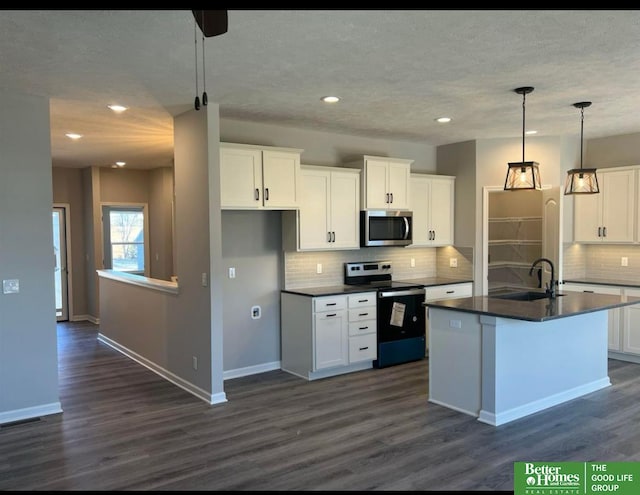 kitchen with stainless steel appliances, sink, and white cabinets