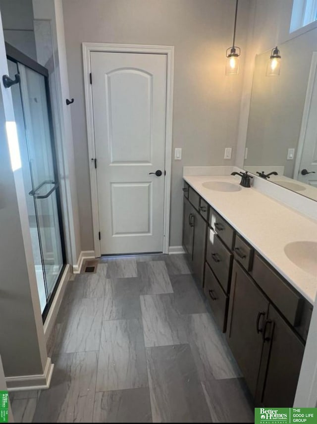 bathroom featuring an enclosed shower and vanity