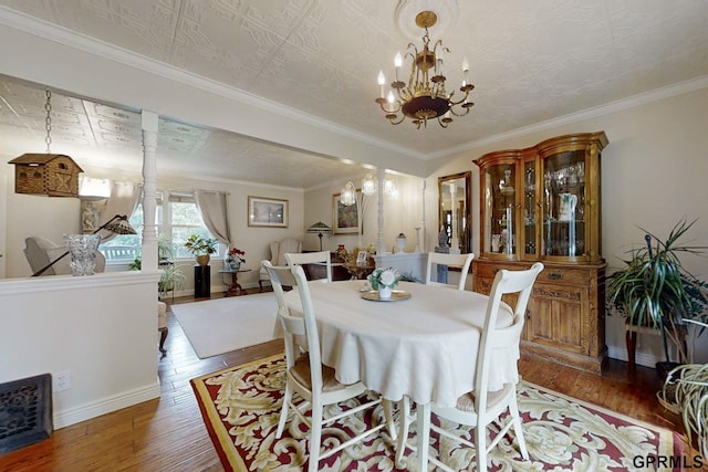 dining space featuring a notable chandelier, dark wood-type flooring, and crown molding