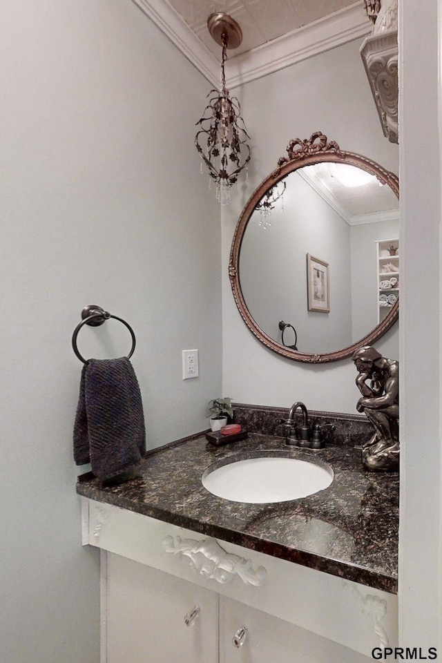 bathroom with ornamental molding and vanity