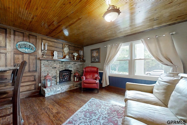 living room featuring wood walls, wood ceiling, a brick fireplace, and hardwood / wood-style floors