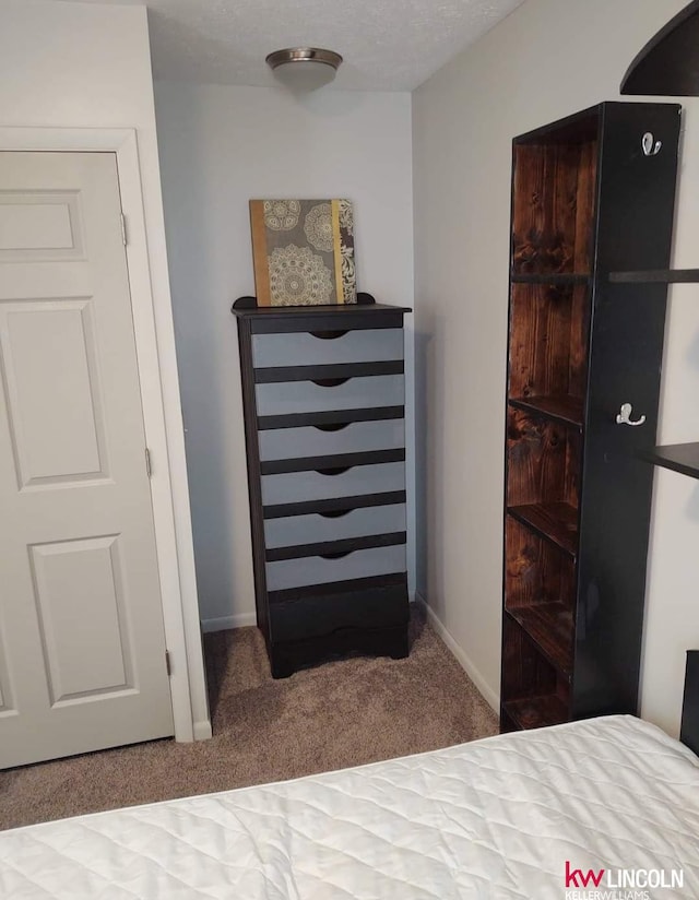 bedroom with baseboards and carpet flooring