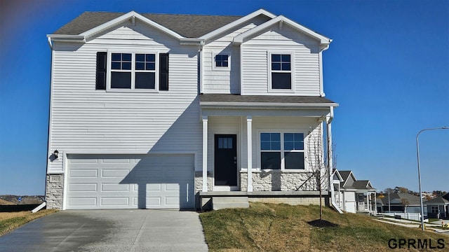 view of front of house with a garage and a front yard