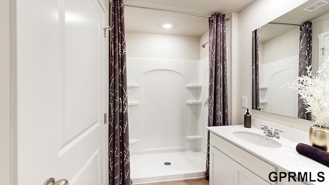 bathroom featuring vanity and a shower with shower curtain