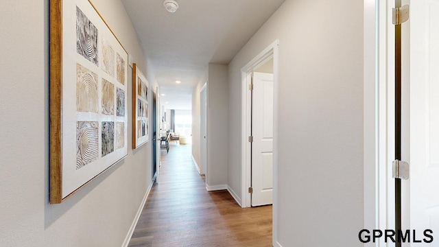 hallway with hardwood / wood-style floors