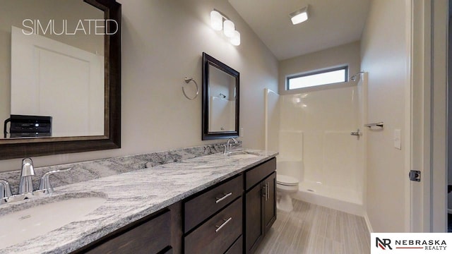 bathroom featuring vanity, vaulted ceiling, toilet, and walk in shower